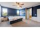 Spacious bedroom with a ceiling fan, neutral walls, and carpeted floors at 10468 W Palm Ln, Avondale, AZ 85392