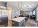 Modern kitchen with an island, stainless steel appliances, and white shaker cabinets at 10468 W Palm Ln, Avondale, AZ 85392