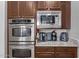 Modern stainless steel kitchen appliances, including a double oven and microwave at 41619 N River Bend Rd, Anthem, AZ 85086