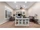 Open living room showcasing a fireplace and large windows at 41619 N River Bend Rd, Anthem, AZ 85086