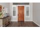 Bright and airy entryway with wood flooring and plantation shutters at 41619 N River Bend Rd, Anthem, AZ 85086