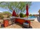 Outdoor kitchen with a built-in grill and granite countertop at 41619 N River Bend Rd, Anthem, AZ 85086