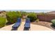 Two lounge chairs overlooking the pool and backyard at 41619 N River Bend Rd, Anthem, AZ 85086