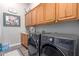 Laundry room with washer, dryer, and cabinets at 41619 N River Bend Rd, Anthem, AZ 85086