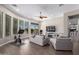 Comfortable living area with hardwood floors, exercise bike, and pool view at 41619 N River Bend Rd, Anthem, AZ 85086