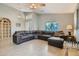 Living room with large leather sectional and tile floors at 28829 N Broken Shale Dr, San Tan Valley, AZ 85143