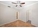 Bedroom with tile floors, ceiling fan and adjacent closet at 10056 E Capri Ave, Mesa, AZ 85208