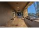 Long covered patio with fireplace, grill, and seating area at 24005 N 45Th Dr, Glendale, AZ 85310