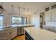 Kitchen island with white quartz countertops and stainless steel dishwasher at 24005 N 45Th Dr, Glendale, AZ 85310