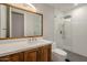 Modern bathroom with a walk-in shower and wood vanity at 24005 N 45Th Dr, Glendale, AZ 85310