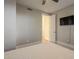 Bright bedroom with TV, carpet, and access to a bathroom at 24005 N 45Th Dr, Glendale, AZ 85310