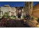 Desert landscape entry with stone walkway leading to a wooden door at 24005 N 45Th Dr, Glendale, AZ 85310