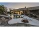 Inviting pool with diving board, surrounded by rocks and desert landscaping at 24005 N 45Th Dr, Glendale, AZ 85310