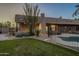Relaxing backyard oasis with a pool, grassy area, and mature trees at 24005 N 45Th Dr, Glendale, AZ 85310