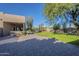 Landscaped backyard with grassy area and paved patio at 24005 N 45Th Dr, Glendale, AZ 85310
