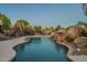 Freeform pool with a rock waterfall and a diving board at 24005 N 45Th Dr, Glendale, AZ 85310