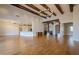 Open living room with hardwood floors, exposed beams, and a large chandelier at 24005 N 45Th Dr, Glendale, AZ 85310