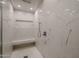 Spa-like shower with marble tile and built-in bench at 24005 N 45Th Dr, Glendale, AZ 85310