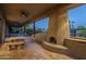 Covered patio with fireplace and seating area at 24005 N 45Th Dr, Glendale, AZ 85310