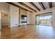 Spacious living room with hardwood floors, fireplace, and sliding doors to backyard at 24005 N 45Th Dr, Glendale, AZ 85310