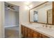 Double vanity bathroom with quartz countertop and wood cabinets at 24005 N 45Th Dr, Glendale, AZ 85310