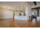 Open kitchen with island, white cabinets, and hardwood floors at 24005 N 45Th Dr, Glendale, AZ 85310