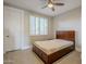 Well-lit bedroom with wood bed frame and window shutters at 24005 N 45Th Dr, Glendale, AZ 85310