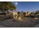 Landscaped front yard with desert plants, rocks, and lighting at 24005 N 45Th Dr, Glendale, AZ 85310