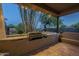 Outdoor kitchen with built-in grill on a covered patio at 24005 N 45Th Dr, Glendale, AZ 85310