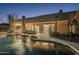 Night view of freeform pool and surrounding landscape at 24005 N 45Th Dr, Glendale, AZ 85310