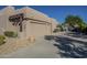 Three car garage with stucco exterior and desert landscaping at 24005 N 45Th Dr, Glendale, AZ 85310