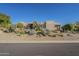 This home features mature desert landscaping and a long driveway at 24005 N 45Th Dr, Glendale, AZ 85310