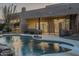 Relaxing freeform pool and spa with a diving board, adjacent to the home at 24005 N 45Th Dr, Glendale, AZ 85310