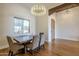 Elegant dining room with rustic wood table and chandelier at 24005 N 45Th Dr, Glendale, AZ 85310