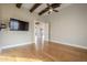 Bedroom with wood floors, ceiling fan and access to other rooms at 24005 N 45Th Dr, Glendale, AZ 85310