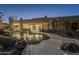 Freeform pool with a waterfall and rock features at night at 24005 N 45Th Dr, Glendale, AZ 85310