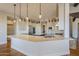 Modern kitchen with island, white cabinets, and stainless steel appliances at 24005 N 45Th Dr, Glendale, AZ 85310