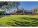 Large backyard with grassy area and mature trees at 24005 N 45Th Dr, Glendale, AZ 85310