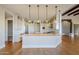 Spacious kitchen with white cabinets, large island, and hardwood floors at 24005 N 45Th Dr, Glendale, AZ 85310
