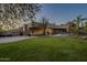 Single-story home with a large grassy yard, pool, and desert landscaping at 24005 N 45Th Dr, Glendale, AZ 85310