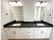 Double vanity bathroom with dark countertops and white cabinets at 58Xx N Nigal Rd, Casa Grande, AZ 85194