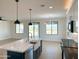Modern kitchen features a farmhouse sink, white quartz counters and a breakfast bar at 58Xx N Nigal Rd, Casa Grande, AZ 85194