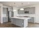 Elegant kitchen with gray cabinets, white quartz counters and a large kitchen island at 58Xx N Nigal Rd, Casa Grande, AZ 85194