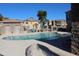 Community pool with surrounding patio furniture and nearby building at 9233 E Neville Ave # 1136, Mesa, AZ 85209