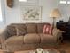 Brown couch with patterned pillows in a well-lit living room at 1318 W Chesapeake Dr, Apache Junction, AZ 85119