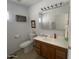 Clean bathroom with a vanity, toilet, and medicine cabinet at 1318 W Chesapeake Dr, Apache Junction, AZ 85119