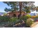 Brick house with a well-manicured front yard and a chain-link fence at 417 N 38Th Ave, Phoenix, AZ 85009