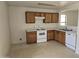 Simple kitchen featuring light wood cabinets and white appliances at 5020 S 25Th Ave, Phoenix, AZ 85041