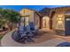 Inviting front porch with seating area and stone wall at 15749 W Roanoke Ave, Goodyear, AZ 85395