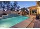 Relaxing pool area with a waterfall and patio seating at 15749 W Roanoke Ave, Goodyear, AZ 85395